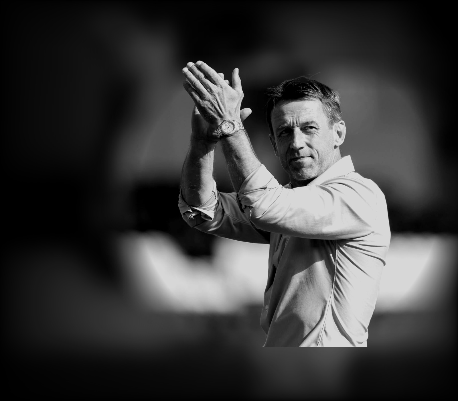 Neil McCann applauding supporters at the side of the pitch